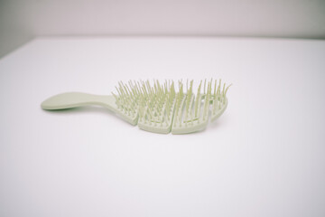 The comb for women is green with sturdy comb bristles that make hair easy to comb