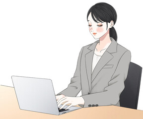 パソコンにむかう仕事のできるスーツ姿の女性