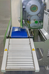 Conveyor Rollers at Labeler Machine Automated Production Line in Factory