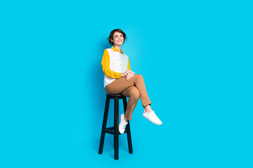 Photo of excited employer girl sit bar chair smiling on interview isolated blue color background