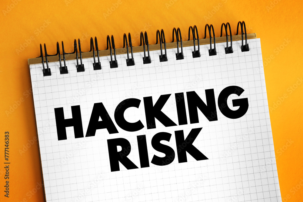 Fototapete Hacking Risk - act of gaining unauthorized access to data in a system or computer, text concept on notepad