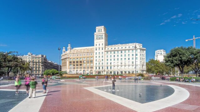 Timelapse Hyperlapse of Activity at Placa de Catalunya, Barcelona's Central Square. A Dynamic Scene with People, a Central Fountain, and a Flowerbed Serving as the Lively Backdrop to City Life