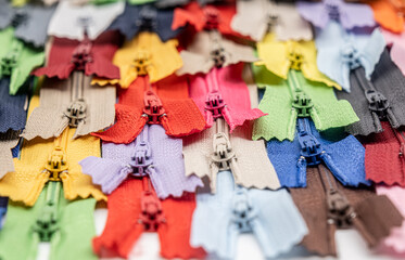 Multicolored Plastic Zippers or Zip Fasteners with sliders pattern for handmade sewing tailoring used for binding fabric or textile
