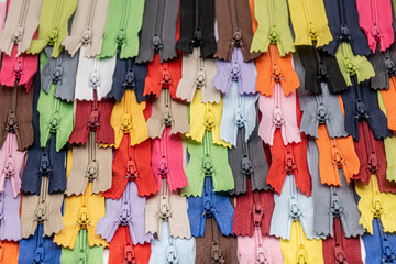Multicolored Plastic Zippers or Zip Fasteners with sliders pattern for handmade sewing tailoring...
