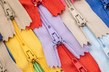 Multicolored Plastic Zippers or Zip Fasteners with sliders pattern for handmade sewing tailoring...