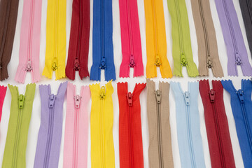 Multicolored Plastic Zippers or Zip Fasteners with sliders pattern for handmade sewing tailoring...