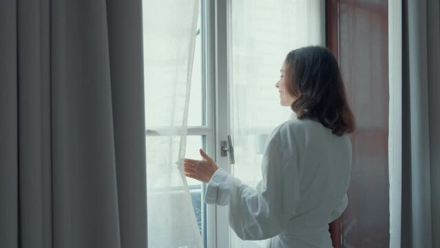 Woman Holding a Cup by Window