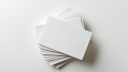 A stack of blank business cards isolated on a white background in a top view.