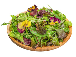 Green vegan salad from green leaves mix and vegetables and flowers on a wooden plate isolated on white background. clipping path included