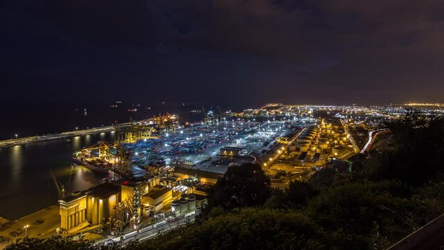 Day to Night Transition Timelapse of Seaport and Loading Docks at Barcelona's Port. Aerial Top View from Montjuic Hill, Illuminating the Scene with the City Lights After Sunset
