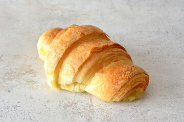 a croissant isolated on the pastel background close up   