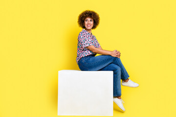 Full length photo of sweet dreamy lady dressed shirt sitting platform looking empty space isolated yellow color background - obrazy, fototapety, plakaty