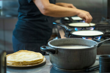 The cook making pancakes in a kitchen on restaurant. Preparation food concept