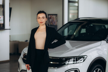 Fototapeta na wymiar Car dealer woman. Auto dealership and rental concept background.