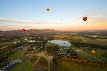 Hot air balloons in Pokolbin wine region, aerial image of wineries and vineyards from balloon Hunter Valley, NSW, Australia	