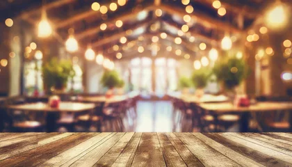 Fotobehang empty wood table top on blur light gold bokeh of cafe restaurant in dark background © netsay