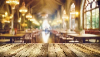 Rucksack empty wood table top on blur light gold bokeh of cafe restaurant in dark background © netsay