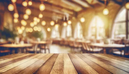 Zelfklevend Fotobehang empty wood table top on blur light gold bokeh of cafe restaurant in dark background © netsay