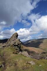 Fototapeta na wymiar Well trodden path leads up to the Lion and Lamb rocky outcrop at the top of Helm Crag near Grasmere in the Lake District national park, UK.