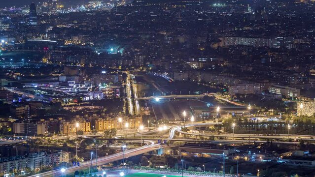 Day to Night Transition Timelapse of Barcelona and Badalona Skylines. Aerial View from Iberic Puig Castellar Village Viewpoint, Capturing Road Intersection, and Gradual Transition from Sunset to Night