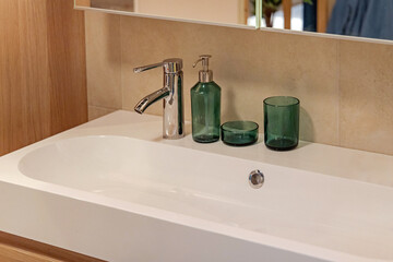 Long Sink Faucet and Glass Soap Dispenser in Modern Bathroom