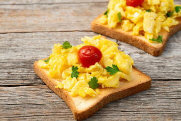 Healthy vegetarian breakfast . Scrambled eggs toast with cherry tomatoes and parsley