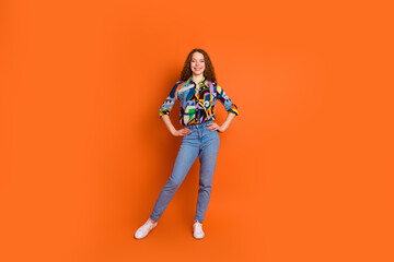 Photo of lovely positive girl wear stylish print clothes collection isolated on vivid orange color background