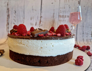chocolate cake frosting. on the side to indicate the year of birth. sliced raspberries and...