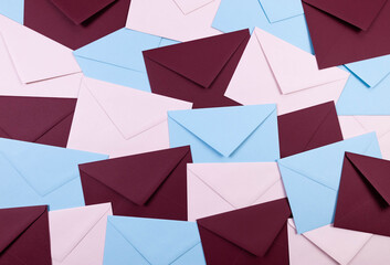 Top view of colourful envelopes. Pink, blue and dark red envelopes flat lay. Copy space.