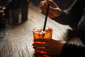 Aperol spritz cocktail in hands. Bar concept.