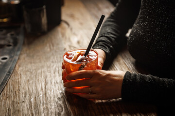 Aperol spritz cocktail in hands. Bar concept.