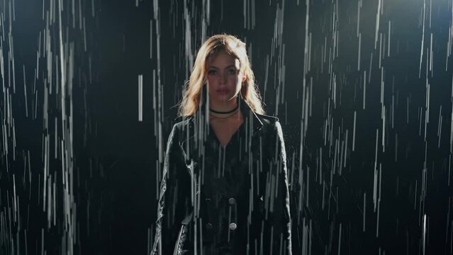 Fashion model posing adult girl in the rain dark night citycity street water drops falling shadow silhouette beauty woman sexy face eyes lips wet blonde hair, aqua studio shower black background, 4k