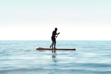Silhouette of a kayaker on a personal rowing kayak, rowing a kayak with an oar in the calm waters of the ocean at dawn. Summer sports holiday on the water in the sea