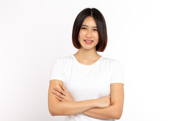 Portrait of a asian woman standing with arms folded and looking at camera isolated on white background