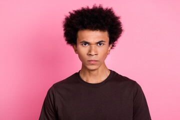 Closeup photo of young mad funny curly guy chevelure hair aggressive looking at you with angry face isolated on pink color background