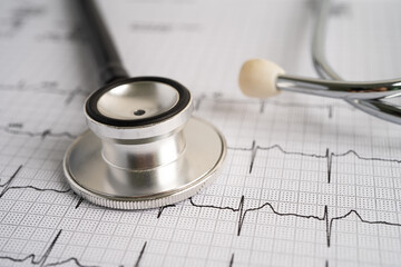 Stethoscope on electrocardiogram ECG, heart wave, heart attack, cardiogram report.