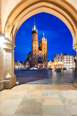 Cracow, Poland old town and St. Mary's Basilica seen from Cloth hall arch at night