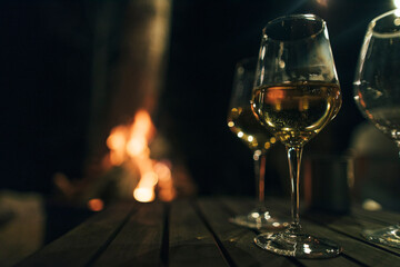 Pair of glasses with wine at fireplace, copy space