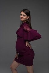 pregnant woman on a grey background, studio pregnancy photo shoot, studio pregnancy, maternity style