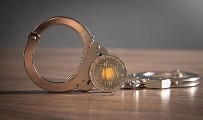 Golden bitcoin and handcuffs. Virtual currency - 777269338