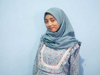 portrait of Beautiful Asian woman in blue dress and hijab. isolated on white background
