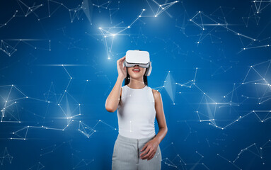 Female stand wear white VR headset and white sleeveless connect metaverse, future technology create...