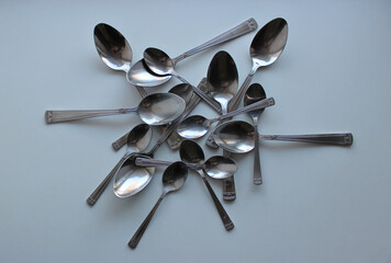 Disordered Spoons From Cutlery Set On Clean White Surface Stock Photo For Cutlery Background
