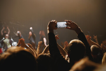 A mesmerizing moment unfolds at a live concert, recorded via mobile phone camera.