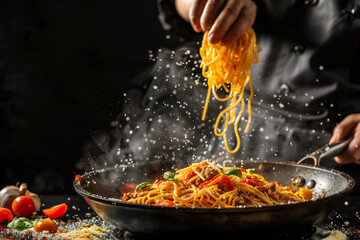 A chef is cooking the noodles in hot oil, which has just been fried with vegetables and meat on it....