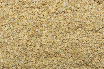 Rolled oat, oat flakes background or texture. Close up, directly above.