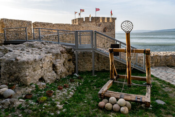 Ancient medieval catapult replica and cannon balls at the Golubac fortress in Serbia. Europe.
