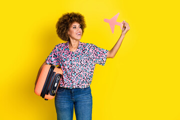 Photo of dreamy sweet lady dressed leopard print shirt rising paper plane holding baggage isolated...