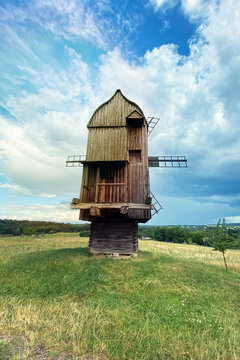 Old wooden mill. Authentic house in the vintage style. Installation in museums of traditional rural style. Windmill.