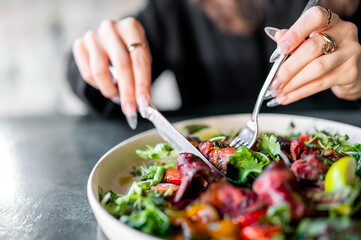 A person enjoys a vibrant, fresh salad—a moment of healthy eating
